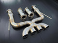 Set of metallic exhaust pipes on a dark background
