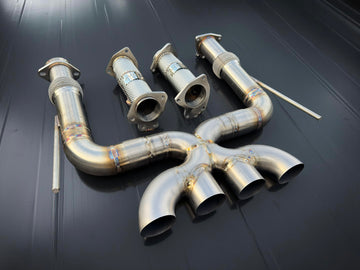 Set of metallic exhaust pipes on a dark background